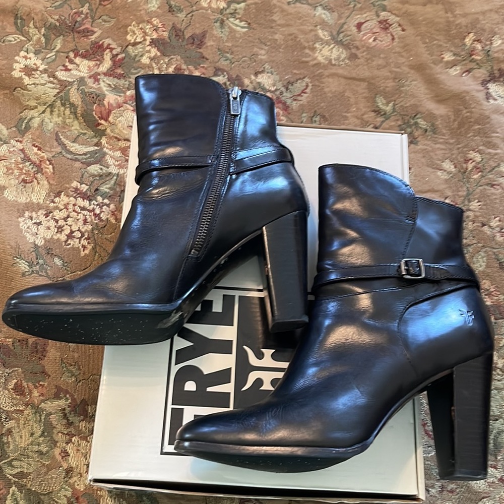 Frye black leather ankle boots with buckle detail.